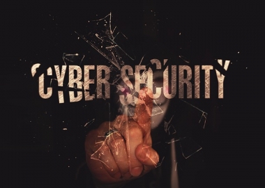 Hand break glass that says cybersecurity