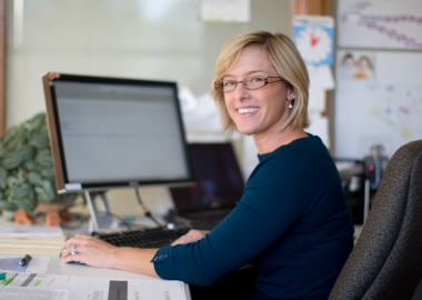 Smiling woman at computer desk