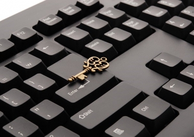 Keyboard with ornate key sitting on top of it