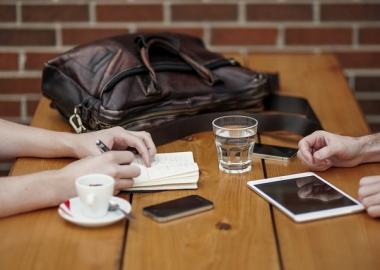 Table with coffee cub, tablet and cell phone