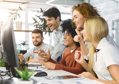 Coworkers around computer