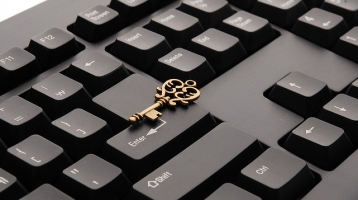 Keyboard with ornate key sitting on top of it 