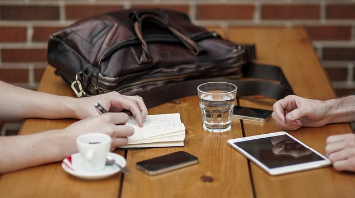 Table with coffee cub, tablet and cell phone