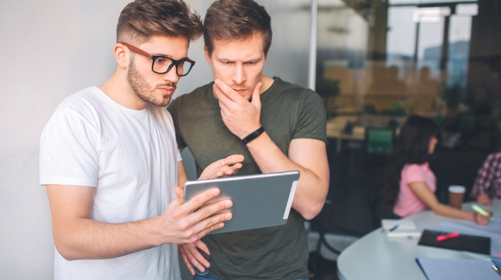 two coworkers with ipad