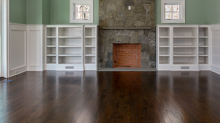 beautiful dark hardwood floor in a living room with a fireplace
