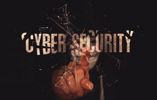 Hand break glass that says cybersecurity