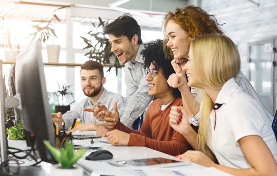 Coworkers around computer