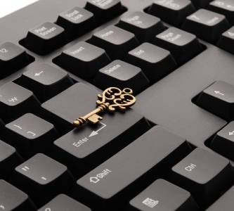 Keyboard with ornate key sitting on top of it 