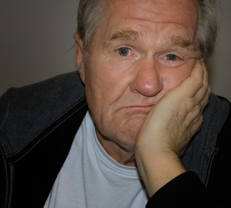 Older man with chin in his hand