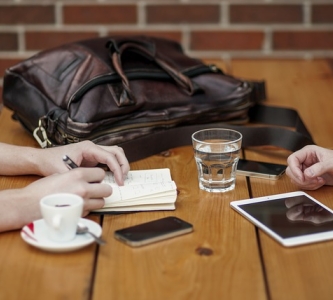 Table with coffee cub, tablet and cell phone