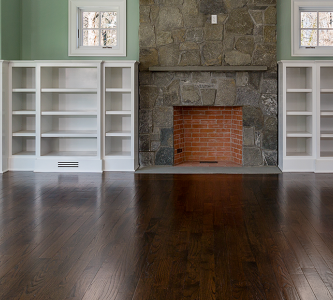beautiful dark hardwood floor in a living room with a fireplace