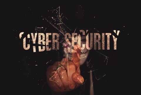 Hand break glass that says cybersecurity