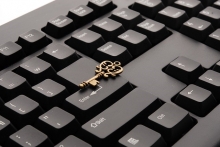 Keyboard with ornate key sitting on top of it 