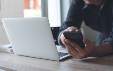 man on mobile and laptop